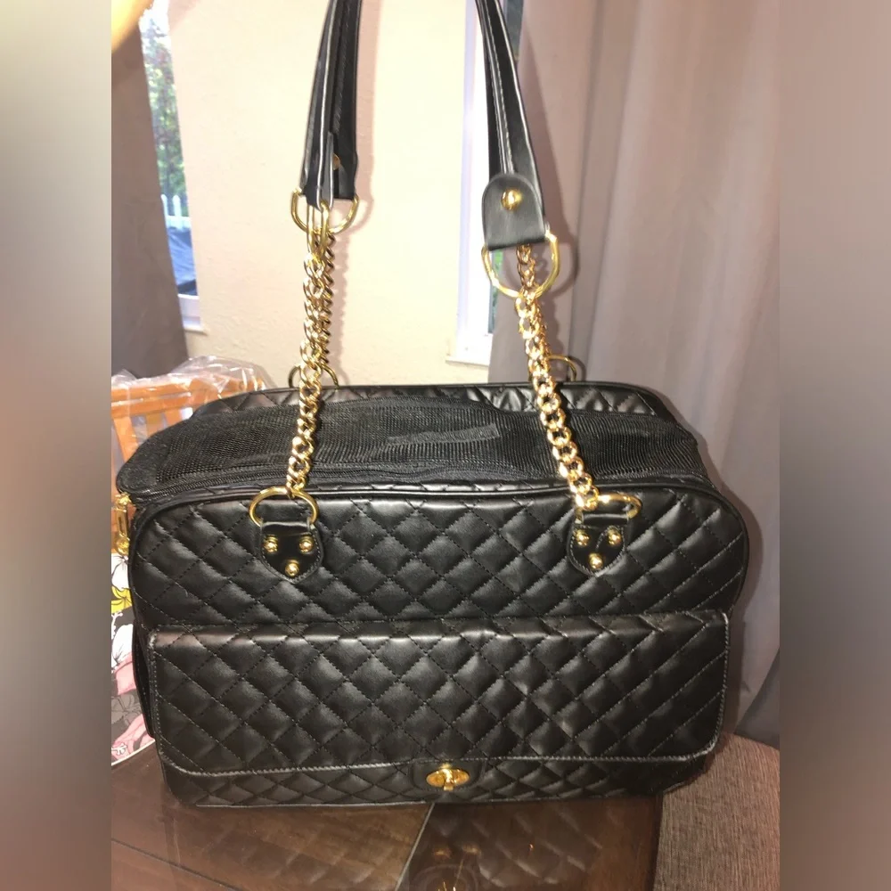 black quilted pet carrier tote with gold chain handles.